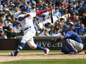 Javier Baez of the Chicago Cubs belts a two-run homer against the Toronto Blue Jays in interleague action Friday at Wrigley Field in Chicago. The Cubs were 7-4 winners.