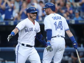Josh Donaldson, left, of the Toronto Blue Jays is congratulated by Justin Smoak after hitting a two-run homer in the first inning of Monday's MLB game against the Tampa Bay Rays at Rogers Centre. The homer would be all the offence needed by the Jays in a 2-1 victory.