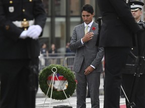 Prime Minister Justin Trudeau makes the sign of the cross as he lays a wreath during a ceremony in honour of the 75th anniversary of the Dieppe Raid, at the National War Memorial in Ottawa on Tuesday, Aug. 22, 2017. THE CANADIAN PRESS/Justin Tang