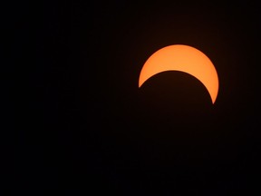 The moon covers the sun during a partial solar eclipse in Ottawa on Monday, August 21, 2017. THE CANADIAN PRESS/Sean Kilpatrick