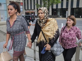 Kobra Mohammadi, centre, mother of Maryam Rashidi, arrives at court with family members for the sentencing hearing for Cody Mitchell, convicted of manslaughter in gas-and-dash death of Maryam Rashidi, in Calgary, Alta., Wednesday, Aug. 30, 2017.