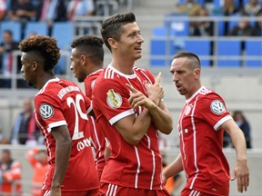 Bayern's Robert Lewandowski celebrates after scoring his second goal during the German soccer cup match between Chemnitzer FC and and FC Bayern Munich in Chemnitz, eastern Germany, Saturday, Aug. 12, 2017. (AP Photo/Jens Meyer)