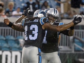 Carolina Panthers quarterback Cam Newton (1) celebrates after throwing a pass for a touchdown to wide receiver Kelvin Benjamin (13) during the first half of an NFL preseason football game against the Jacksonville Jaguars, Thursday, Aug. 24, 2017, in Jacksonville, Fla. (AP Photo/Stephen B. Morton)