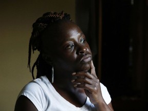 In this July 24, 2017 photograph, Otibehia Allen, a single mother of five, peers outside her rented mobile home in the same isolated, low-income community of Jonestown, Miss., where she grew up among the cotton and soybean fields of the Mississippi Delta. She works 30 hours a week at barely over minimum wage. (AP Photo/Rogelio V. Solis)