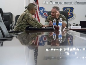 Joint Chiefs Chairman Gen. Joseph Dunford, right, speaks with United States Forces Korea Commander Gen. Vincent Brooks, left, at Osan Air Base, Sunday, Aug. 13, 2017, in Pyeongtaek, South Korea. (AP Photo/Andrew Harnik)