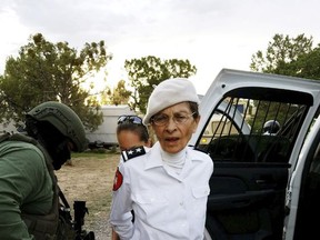 In this Aug. 20, 2017 photo provided by the Cibola County Sheriff's Office, Deborah Green, leader of the paramilitary Christian sect Aggressive Christianity Missions Training Corps, is arrested outside of the group's secluded Fence Lake, N.M., compound after Cibola County deputies raided the grounds. Green and seven members of the group are facing charges in connection with a child abuse and child sexual abuse investigation in New Mexico. (Cibola County Sheriff's Office via AP)