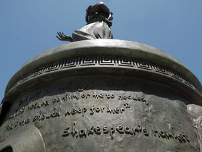 A quote attributed to William Shakespeare is seen on the base of a statue of the legendary queen of Troy on the campus of the University of Southern California in Los Angeles on Tuesday, Aug. 22, 2017. "To E, or not to E, that is the question," the school responded in a statement Tuesday when asked why Shakespeare's name is missing the last letter E in a quotation attributed to him. (AP Photo/Richard Vogel)