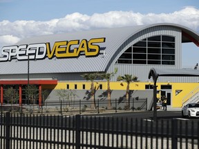 FILE - In this March 21, 2017, file photo, people stand outside of SpeedVegas in Las Vegas. Nevada safety officials are recommending fines of $16,000 against the tourist-oriented exotic auto track where a Canadian man and an instructor died in a fiery crash of a high-performance Lamborghini in February. The state Occupational Safety and Health Administration said SpeedVegas had a substandard fire and safety plan and failed to properly train employees in fire suppression. (AP Photo/John Locher, File)