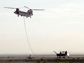 Sierra Nevada Corp's "Dream Chaser" test spacecraft is prepared to be lifted by a helicopter for a test at Edwards Air Force Base, Calif. on Wednesday, Aug. 30, 2017. The test version of a spacecraft resembling a mini space shuttle was carried aloft over the Mojave Desert by a helicopter in a precursor to a free flight in which it will be released to autonomously land on a runway as it would in an actual return from orbit. Sierra Nevada Corp.'s Dream Chaser craft was lifted off the ground at NASA's Armstrong Flight Research Center on Edwards Air Force Base and was carried to the same altitude and flight conditions it will experience before release in a free flight. (Matt Hartman via AP)