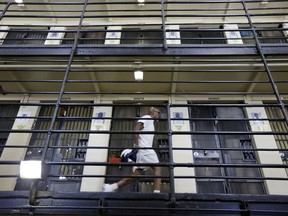 FILE - In this Aug. 16, 2016 file photo, a condemned inmate walks along the east block of death row at San Quentin State Prison in San Quentin, Calif. California's Supreme Court has announced it will issue a long-awaited ruling on Proposition 66, the measure voters approved in 2016 to speed up the death penalty. The decision will be released Thursday morning, Aug. 24, 2017. (AP Photo/Eric Risberg, File)