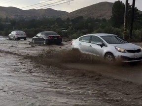 This video image courtesy of Andy Villalobos shows flooding in Acton, Calif. Moist, monsoonal air is causing storms and forecasters say they could dump up to an inch of rain per hour. The National Weather Service has issued flood watches for the mountains and the Antelope Valley through the evening. (Andy Villalobos via AP)