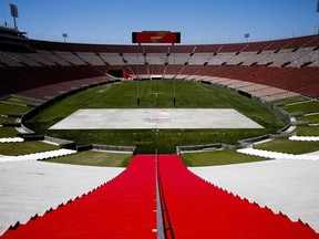 FILE - In this May 11, 2017, file photo, Los Angeles Memorial Coliseum, the venue proposed for Olympic opening and closing ceremonies and track and field events. stands in Los Angeles. The Los Angeles City Council is expected Friday, Aug. 11, 2017 to endorse a proposal to host the 2028 Olympics, following an announcement of a deal last month to leave 2024 to Paris. (AP Photo/Jae C. Hong, File)