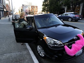 FILE - In this March 12, 2014 file photo, Katie Baranyuk gets out of a car driven by Dara Jenkins, a driver for the ride-sharing service Lyft, after getting a ride to downtown Seattle. For the second time this month, a federal judge has rejected a challenge to Seattle's first-in-the-nation law allowing drivers of ride-hailing companies such as Uber and Lyft to unionize over pay and working conditions, Thursday, Aug. 24, 2017. (AP Photo/Ted S. Warren, File)