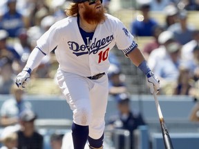 Los Angeles Dodgers' Justin Turner watches his three-run home run against the San Diego Padres during the fourth inning of a baseball game in Los Angeles, Sunday, Aug. 13, 2017. (AP Photo/Alex Gallardo)