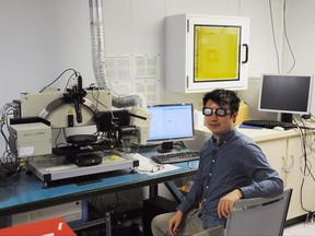 Herman Wong, a University of Toronto engineering and photonics Phd. student, tests eclipse glasses with an ellipsometer at the University of Toronto on Thursday, August 10, 2017. THE CANADIAN PRESS/Lucas Timmons