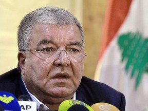 In this Nov. 15, 2015, file photo, Lebanese Interior Minister Nohad Machnouk holds a press conference at the police headquarter in Beirut, Lebanon. Machnouk said Monday that the country's police intelligence played a major role in foiling a plot to bring down an Emirati passenger plane that was supposed to take off from Sydney in Australia to the United Arab Emirate capital of Abu Dhabi.