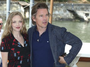 Actors Amanda Seyfried, left, and Ethan Hawke pose for photographers upon arrival for the press conference of the film 'First Reformed' during the 74th edition of the Venice Film Festival in Venice, Italy, Thursday, Aug. 31, 2017. (Photo by Joel Ryan/Invision/AP)