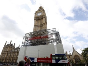 FILE - In this Aug. 3, 2017 file photo, scaffolding is erected around the Elizabeth Tower, which includes the landmark 'Big Ben' clock, as part of ongoing conservation efforts at the Palace of Westminster in London. The Big Ben bell is due to sound the hour for the last time at noon on Monday, Aug. 21, 2017, before it's silenced for repair work scheduled to last until 2021. (AP Photo/Caroline Spiezio, File)