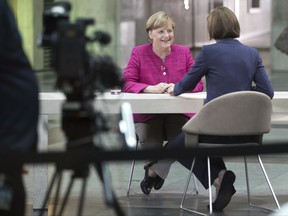 German Chancellor Angela Merkel, left, is being hosted by presenter Bettina Schausten during the filming of the ZDF show "Berlin direct" in Berlin, Germany, 27 August 2017. Merkel said she wants to continue ruling the country to help improving the 82 million Germans' wealth, security and fostering solidarity among all parts of society. (Joerg Carstensen/dpa via AP)