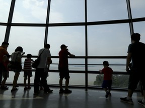 Visitors watch the North side from the unification observatory in Paju, South Korea, Sunday, Aug. 6, 2017. The U.N. Security Council unanimously approved tough new sanctions Saturday to punish North Korea for its escalating nuclear and missile programs including a ban on coal and other exports worth over $1 billion - a huge bite in its total exports, valued at $3 billion last year.(AP Photo/Lee Jin-man)