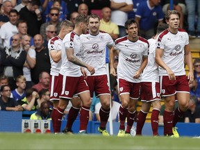 Burnley's players celebrate their side's first goal during the English Premier League soccer match between Chelsea and Burnley at Stamford Bridge stadium in London, Saturday, Aug. 12, 2017. (AP Photo/Kirsty Wigglesworth)