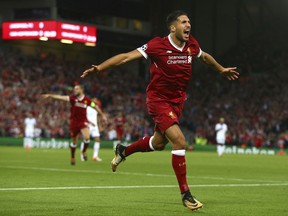 Liverpool's Emre Can celebrates scoring his sides first goal during the Champions League qualifying play-off second leg soccer match between Liverpool and Hoffenheim at Anfield stadium in Liverpool, England, Wednesday, Aug. 23, 2017. (AP Photo/Dave Thompson)