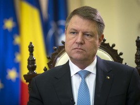FILE - In this Wednesday, Feb. 8, 2017 file photo, Romania's president Klaus Iohannis listens to a question during an interview with the Associated Press at the Cotroceni Palace in Bucharest, Romania. Romania's justice minister has presented a package of proposed changes to the judicial system on Wednesday, Aug. 23, 2017 that would limit the role of the president in naming key officials. Romania's president Iohannis says the proposals would set the country's anti-corruption fight back by a decade.  (AP Photo/Darko Bandic, file)