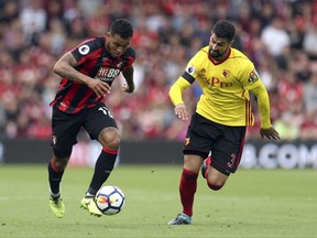 AFC Bournemouth's Joshua King, left, and Watford's Miguel Britos battle for the ball during the Premier League match at the Vitality Stadium, Bournemouth, England, Saturday, Aug. 17, 2017. (Steven Paston/PA via AP)