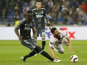FILE - A Thursday, May 11, 2017, file photo of Ajax's Davinson Sanchez, left,  tackling Lyon's Nabil Fekir, during the second leg semi final soccer match between Olympique Lyon and Ajax in the Stade de Lyon, Decines, France. The tall Colombia center back missed Ajax's first game of the season, a 2-1 loss to Heracles Almelo in the Eredivisie, because club management didn't feel he was in the right frame of mind to play. (AP Photo/Laurent Cipriani, File)
