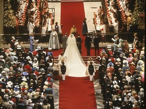 FILE - This is a July 29, 1981 file photo of Prince Charles and his bride Diana, Princess of Wales, during their wedding ceremony  in St. Paul's Cathedral in London. The bride's maids and the groom's brothers Prince Andrew, top left, and Prince Edwards, top right, march behind them.  Thirty-six years after Lady Diana Spencer married Prince Charles, The Associated Press has restored original footage from the wedding and is making it available to the public on YouTube. (AP Photo/File)