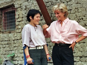 FILE --In this Sunday August 10,1997 file photo, Britain's Diana, Princess of Wales, right, chats with Bosnian muslim girl Mirzeta Gabelic, a 15 year-old landmine victim, in front of Mirzeta's home in Sarajevo, while Diana was on a visit to the region as part of her campaign against landmines. Bosnia is marking Thursday, Aug. 10, 2017, the 20th anniversary of Princess Diana's visit, her last overseas tour only weeks before she died in a car crash in Paris. (AP Photo /Hidajet Delic, File)
