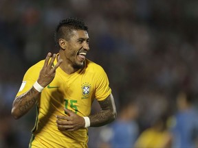 FILE- In this Thursday, March. 23, 2017 file photo, Brazil's Paulinho celebrates his hat trick during a 2018 World Cup qualifying soccer match against Uruguay in Montevideo, Uruguay. Barcelona says it has reached a deal with Chinese club Guangzhou Evergrande to buy Brazil midfielder Paulinho for 40 million euros ($47 million). (AP Photo/Natacha Pisarenko, File)