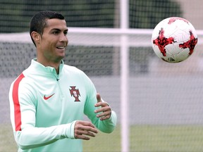 FILE - In this Friday, June 23, 2017 file photo, Portugal's Cristiano Ronaldo controls the ball during a training session in St. Petersburg, Russia. Cristiano Ronaldo is rested and ready to take on Barcelona in the Spanish Super Cup. Ronaldo enjoyed a longer vacation than his Real Madrid teammates to recover fully from Portugal's participation in the Confederations Cup in June. That meant he missed his club's preseason tour and a friendly against Barcelona in Miami that the Catalan club won 3-2. (AP Photo/Dmitri Lovetsky, file)