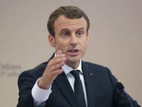 FILE - In this Thursday, July 27, 2017 file photo, French President Emmanuel Macron gestures as he delivers a speech during a citizenship ceremony in Orleans, central France. French President Emmanuel Macron is pushing for tighter European rules to protect workers in France and other prosperous countries in Western Europe from cheaper labor primarily stemming from the continent's east. Macron is set to raise concerns over so-called "posted workers" and "social dumping" with leaders across Central Europe as he makes his first visit to the region this week. (AP Photo/Michel Euler, file)