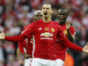 FILE - This is a Sunday, Feb. 26, 2017 file photo of Manchester United's Zlatan Ibrahimovic  as he celebrates after scoring the opening goal during the English League Cup final soccer match between Manchester United and Southampton FC at Wembley stadium in London. Ibrahimovic has signed a new one-year deal with Manchester United. United made the announcement on Thursday Aug. 24, 2017. (AP Photo/Kirsty Wigglesworth, File)