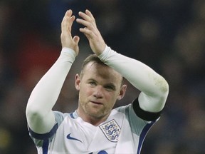 FILE - This is a Friday, Nov. 11, 2016  file photo of England's Wayne Rooney as he claps after winning the World Cup group F qualifying soccer match between England and Scotland with a 3-0 score at the Wembley stadium, London. England striker Wayne Rooney announced his immediate retirement from international football on Wednesday Aug. 23, 2017. (AP Photo/Matt Dunham/File)