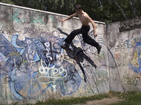 FILE - A Thursday, Aug. 6, 2009 file photo of a Parkour practitioner jumping in the southern Russian city of Krasnodar, about 1,200 km (750 miles) south of Moscow. Global organizers of street-running known as parkour have set the International Gymnastics Federation (FIG) a deadline to end attempts to control their sport. Parkour Earth asks FIG President Morinari Watanabe in an open letter for an "urgent meeting" by Sept. 15 to formalize its right to govern. It's the latest dispute involving Olympic sports bodies for control of popular youth-oriented events. (AP Photo/Yuri Ivashchenko, File)