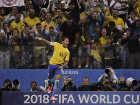 FILE - In this March 28, 2017 file photo, Brazil's Neymar celebrates scoring his side's 2nd goal against Paraguay during a 2018 World Cup qualifying soccer match at the Arena Corinthians Stadium in Sao Paulo, Brazil. Neymar has told Barcelona that he plans to leave the club, with a blockbuster move to Paris Saint-Germain seemingly imminent. Barcelona responded shortly after his announcement Wednesday, Aug. 2, 2017 with a statement saying the Brazil striker's 222 million euro ($262 million) release clause must be paid in full, a scenario which until recently seemed beyond the reach of any rival. (AP Photo/Andre Penner, File)