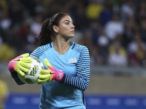 FILE - In this Aug. 3, 2016, file photo, U.S. goalkeeper Hope Solo takes the ball during a women's Olympic football tournament match against New Zealand in Belo Horizonte, Brazil.  American goalkeeper Hope Solo is looking to resume playing and says she had had offers to play overseas. Solo was handed a six-month suspension and her contract with U.S. Soccer was terminated following the Rio de Janeiro Olympics last year, after she called Sweden's team "cowards" for their defensive style of play against the Americans. (AP Photo/Eugenio Savio, File)