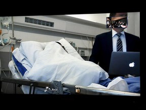Seen on a court video link screen, Moroccan man Abderrahman Mechkah, lays in a hospital bed during the initial remand hearing, on suspicion of murder, attempted murder, and terrorism crimes, at court in Turku, Finland, Tuesday, Aug. 22, 2017.  18-year old Mechkah, who was shot in the leg by police during his arrest, stands accused of killing two people and attempting to kill eight others with terrorist intent. (Martti Kainulainen/Lehtikuva via AP)