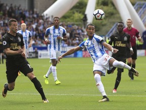 Huddersfield Town's Tom Ince, right, and Newcastle United's Javier Manquillo in action during their English Premier League soccer match at the Kirklees Stadium, Huddersfield, England, Sunday, Aug. 20, 2017. (Danny Lawson/PA via AP)