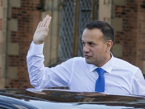 Irish Prime Minister Leo Varadkar waves as he arrives at the university in Belfast to make a speech on his first visit to Northern Ireland, Friday Aug. 4, 2017. Varadkar said Friday that a so-called "hard Brexit," with Britain leaving the EU single market, would mean "barriers to commerce and trade" between EU member Ireland and Northern Ireland, part of the U.K. saying Brexit is the challenge of a generation, and "unique solutions" will be needed to prevent it doing major damage. (Liam McBurney/PA via AP)