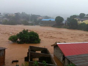 In this image made available by Society 4 Climate Change Communication, Sierra Leone, mud and water flow in Freetown Sierra Leone Monday Aug. 14, 2017. Mudslides after heavy rains and flooding killed scores of people in Sierra Leone's capital on Monday. ( Society 4 Climate Change Communication via AP)