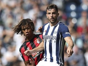 AFC Bournemouth's Nathan Ake, left, an dWest Bromwich Albion's Jay Rodriguez battle for the ball during the English Premier League soccer match at The Hawthorns, West Bromwich, England, Saturday Aug. 12, 2017. (Nick Potts/PA via AP)