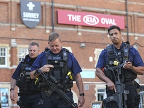 Police secure the area outside The Oval cricket ground in London, after play was suspended in the County Championship clash between Surrey and Middlesex after an arrow was fired onto the pitch, Thursday Aug. 31, 2017.  An arrow was fired onto the field of play at The Oval cricket stadium, and London's Metropolitan Police said there are no reported injuries and that no arrests had been made. (Jonathan Brady/PA via AP)