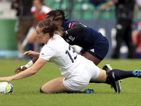 England's Emily Scarratt, front, scores despite a challenge from USA's Cheta Emaba during the 2017 Women's Rugby World Cup, Pool B match at UCD Billings Park, Dublin, Thursday Aug. 17, 2017. (Donall Farmer/PA via AP)