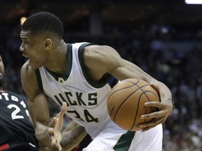 FILE - In this file photo dated Thursday, April 27, 2017, Milwaukee Bucks' Giannis Antetokounmpo runs with the ball during the second half of Game 6 of an NBA first-round playoff series basketball game in Milwaukee, USA.  Greece's basketball federation on Saturday Aug. 19, 2017, has accused the Milwaukee Bucks and the NBA of hatching a plan to prevent Giannis Antetokounmpo from playing in the European championship. (AP Photo/Morry Gash, FILE)