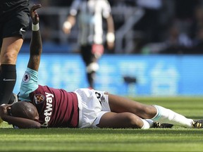 West Ham United's Andre Ayew lies injured during the English Premier League soccer match between Newcastle United and West Ham United at Saint James's Park Stadium, Newcastle, England, Saturday Aug, 26, 2017. (Owen Humphreys/PA via AP)