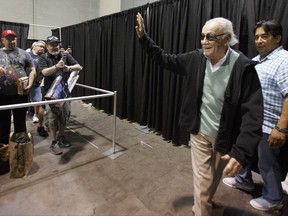 Stan Lee waves to fans as he arrives for an autograph signing at Boston Comic Con, Friday, Aug. 11, 2017, in Boston. The convention is being held at the Boston Convention & Exhibition Center through Sunday. (AP Photo/Michael Dwyer)