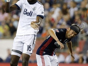 Vancouver Whitecaps' Tony Tchani (16) heads the ball over New England Revolution's Lee Nguyen during the first half of an MLS soccer game Saturday, Aug. 12, 2017, in Foxborough, Mass. (AP Photo/Michael Dwyer)